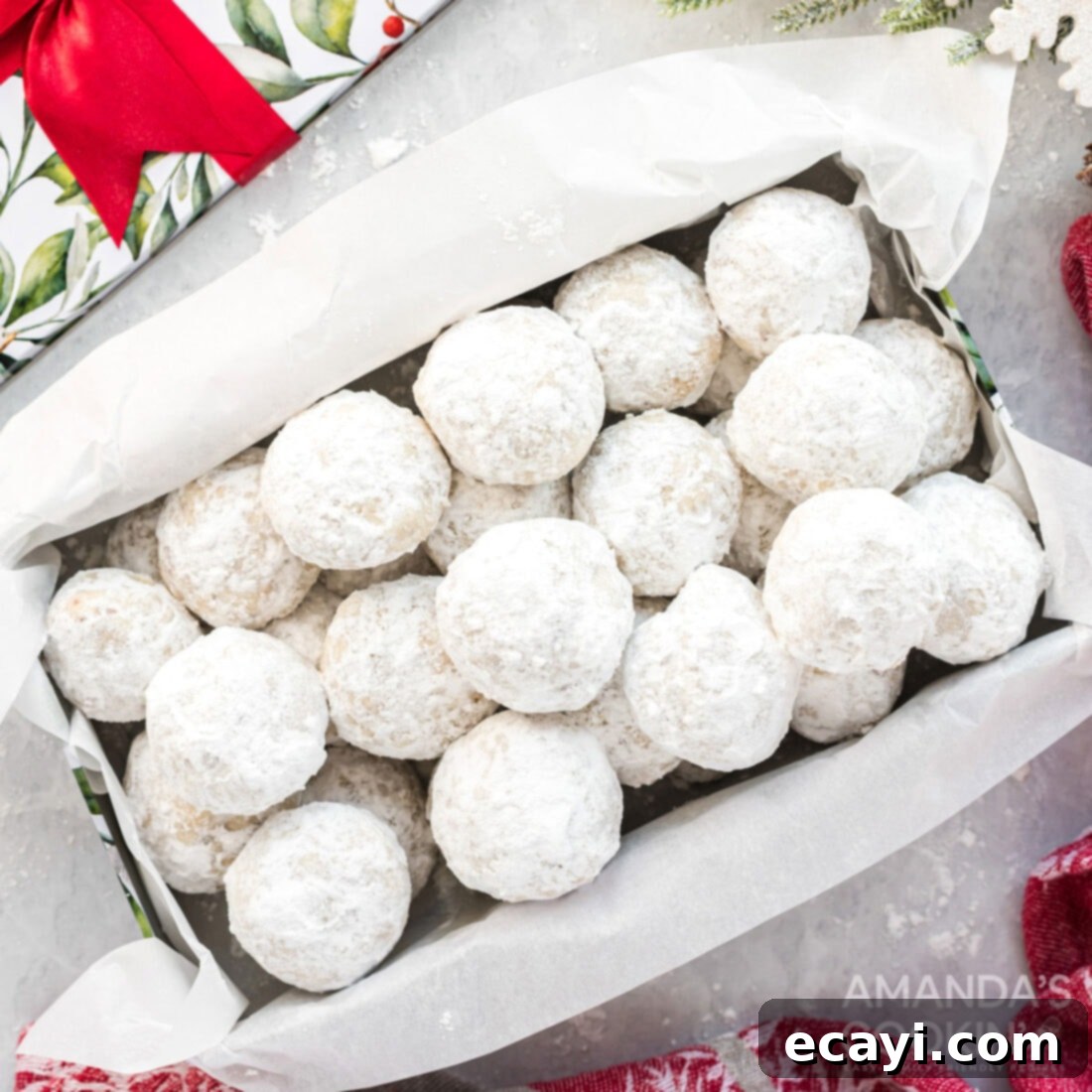 The 2020 Christmas Cookie Countdown: Twelve Days of Sweet Delights 10 A box overflowing with delicate snowball cookies, dusted generously with powdered sugar.