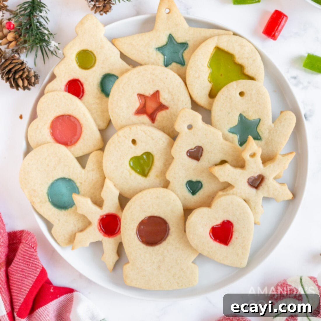The 2020 Christmas Cookie Countdown: Twelve Days of Sweet Delights 12 Beautiful stained glass cookies with colorful melted candy centers, arranged on a plate.