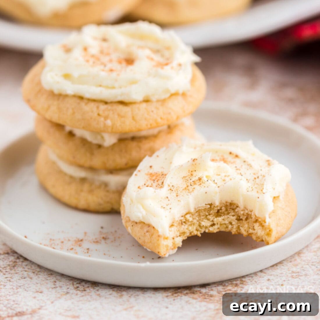 The 2020 Christmas Cookie Countdown: Twelve Days of Sweet Delights 4 Frosted eggnog cookies arranged beautifully on a white plate, ready to be served.