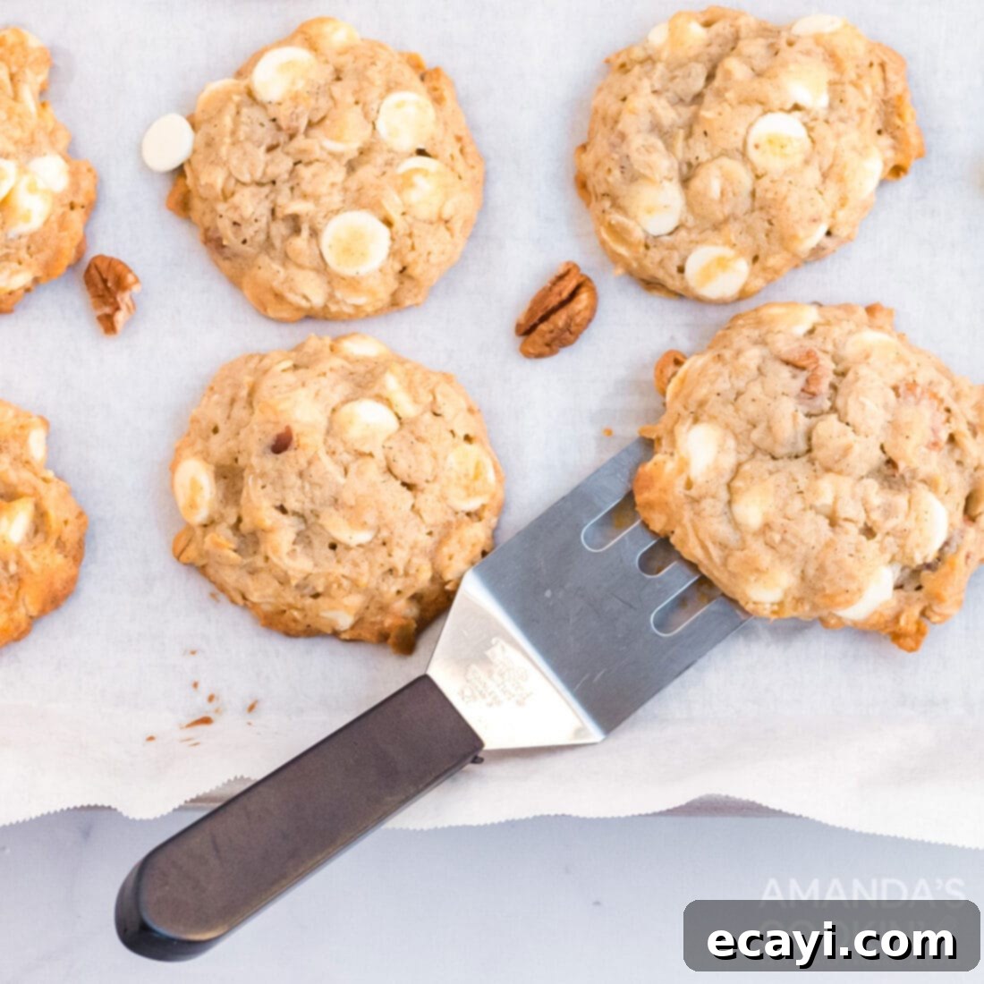 The 2020 Christmas Cookie Countdown: Twelve Days of Sweet Delights 9 Freshly baked banana cookies cooling on a wire rack with a spatula.