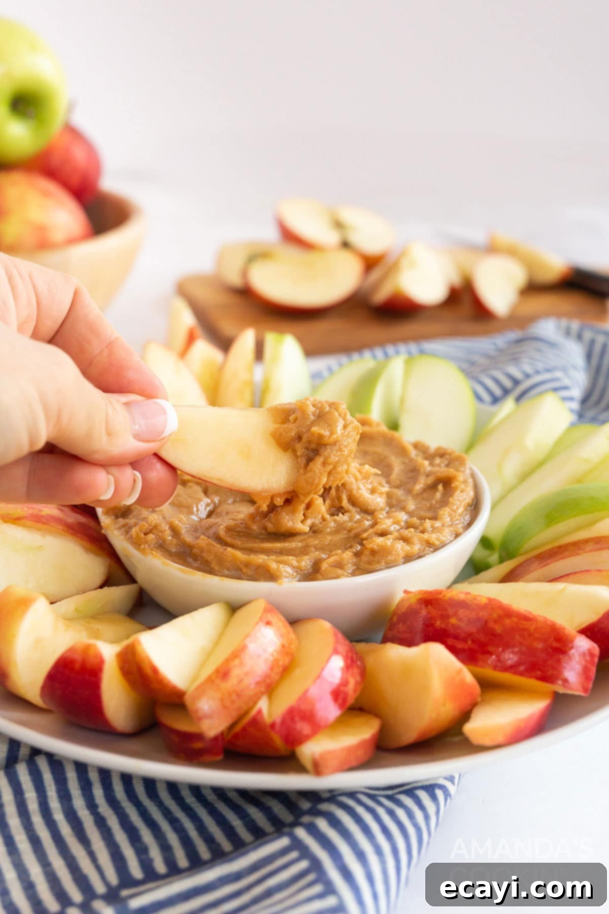 Creamy Peanut Butter Apple Delight 8 person dipping apple slice in peanut butter apple dip