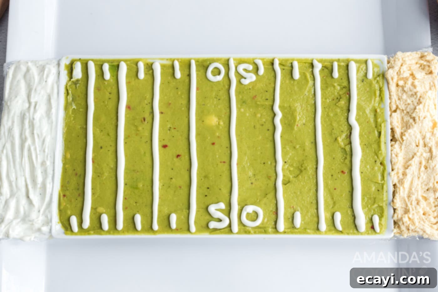 Game Day Grazing Platter 6 The football field party tray with guacamole and sour cream yard lines, flanked by hummus and French onion dip end zones, ready for dippers.