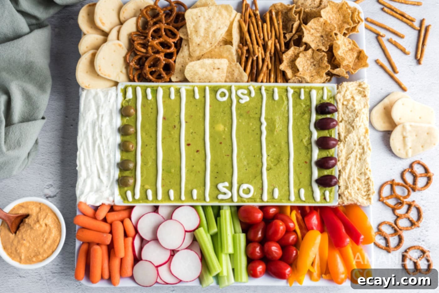 Game Day Grazing Platter 8 An overhead view of the completed football party tray, showcasing the guacamole field, dip end zones, and a colorful assortment of dippers.