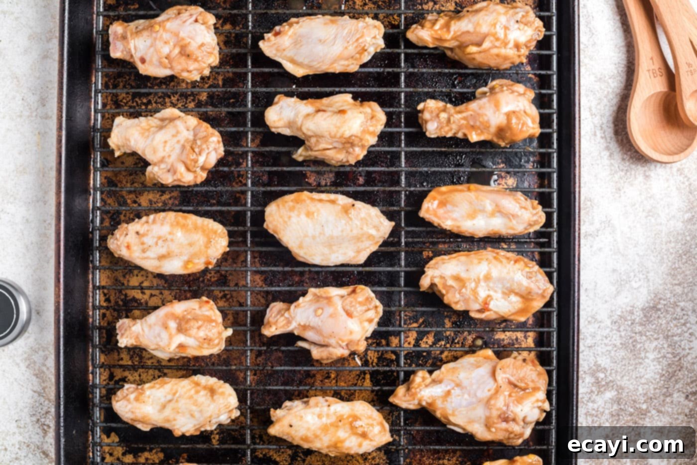 Inferno Wings 7 Arranging chicken wings on a wire rack over a cookie sheet for even baking