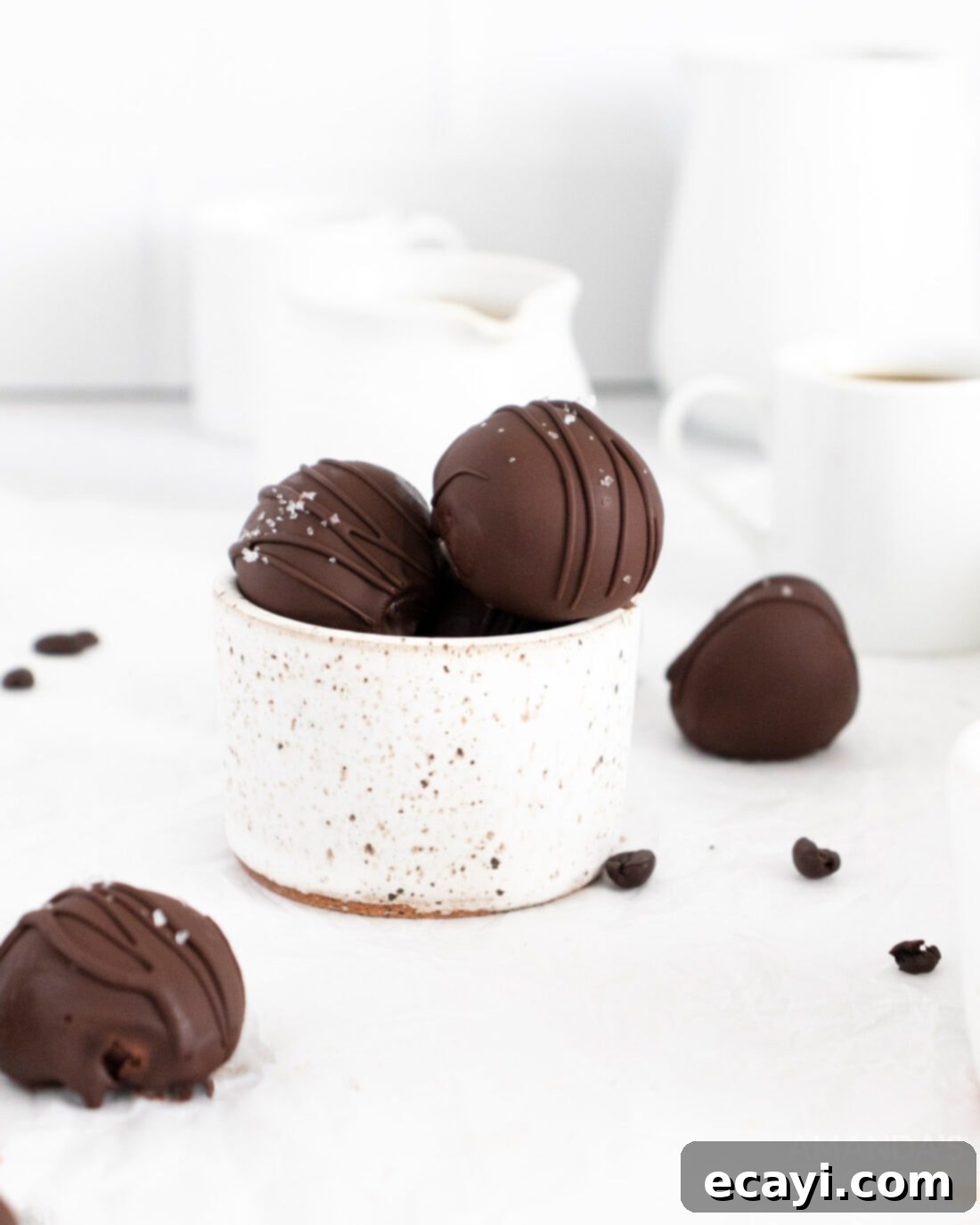 Decadent Mocha Truffles 3 A bowl brimming with perfectly rounded, dark mocha truffles, some coated and some plain, ready for their final delicious touches.