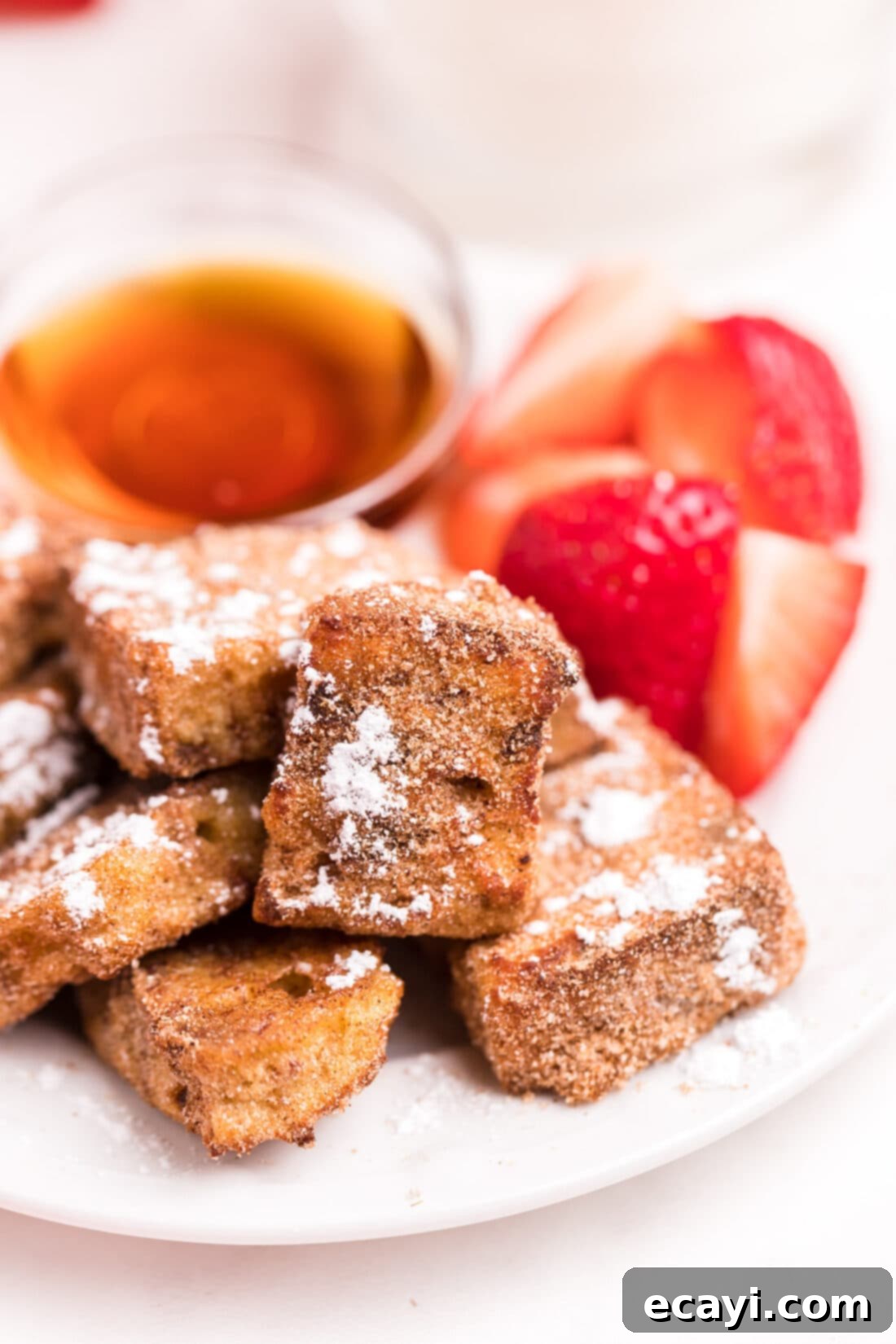 Crispy Air Fryer French Toast Bites 3 plate of Air Fryer French Toast Bites with strawberries on the side
