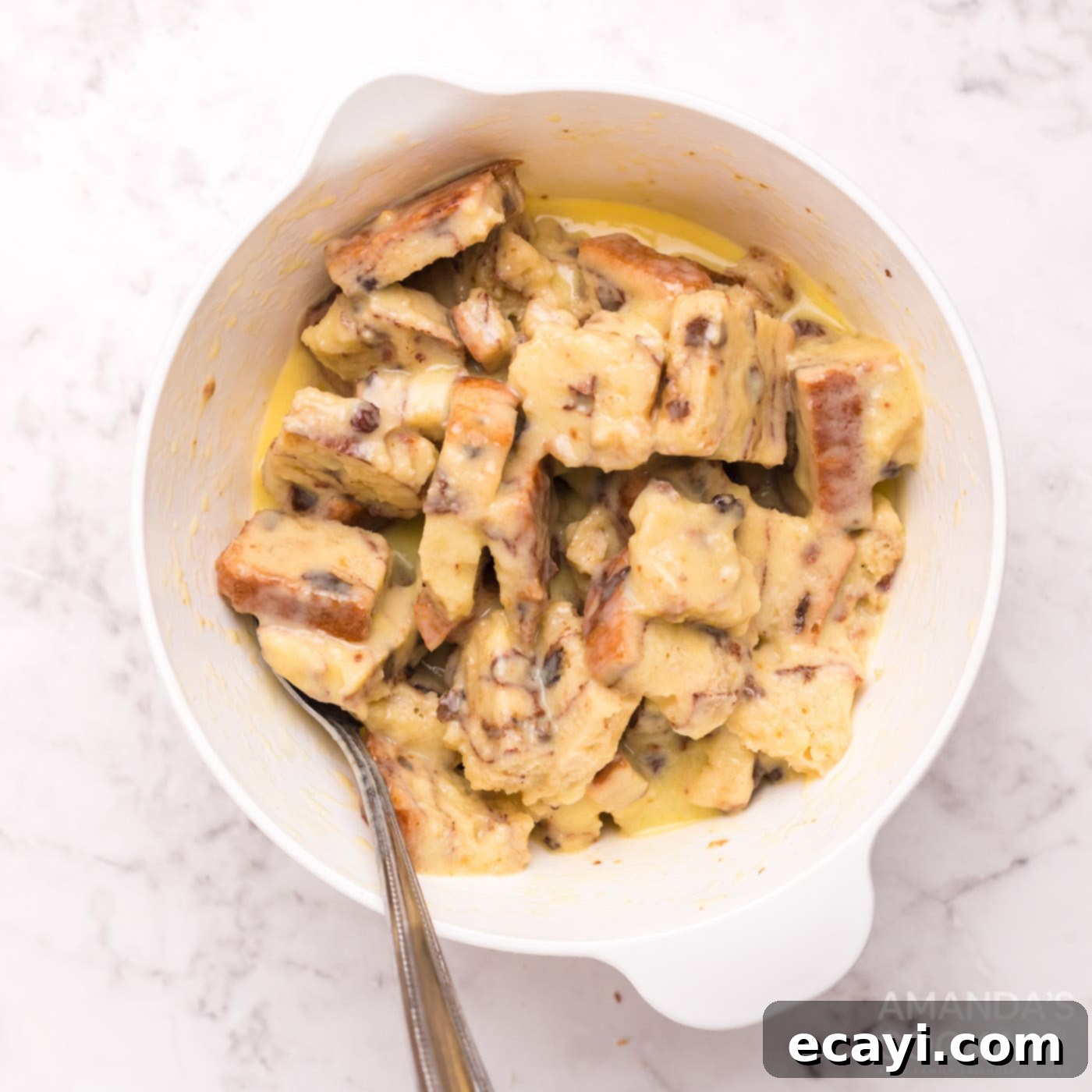 Crispy Air Fryer French Toast Bites 7 bread squares in a bowl of egg mixture