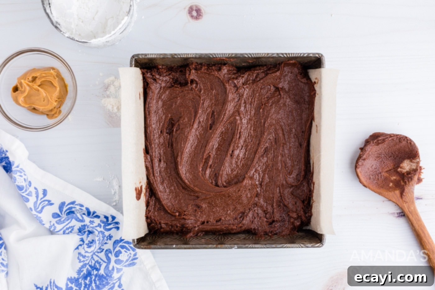 Irresistible Peanut Butter Fudge Brownies 9 Smooth brownie batter spread evenly into a parchment-lined 8x8 inch baking pan