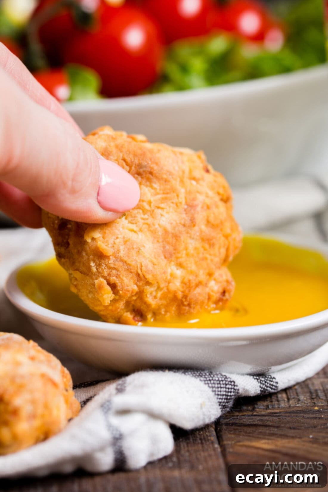 Golden Crunch Air Fryer Nuggets 3 dipping chicken nugget into mustard