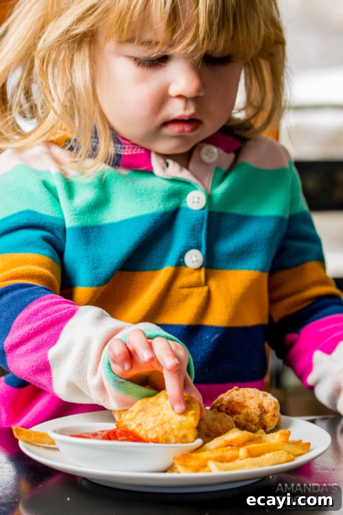Golden Crunch Air Fryer Nuggets 10 little girl dipping an air fryer chicken nugget