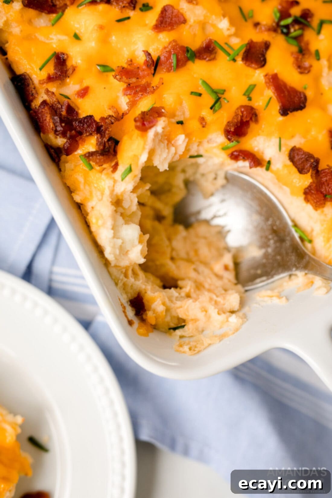 Ultimate Loaded Potato Bake 2 spooning out potato casserole