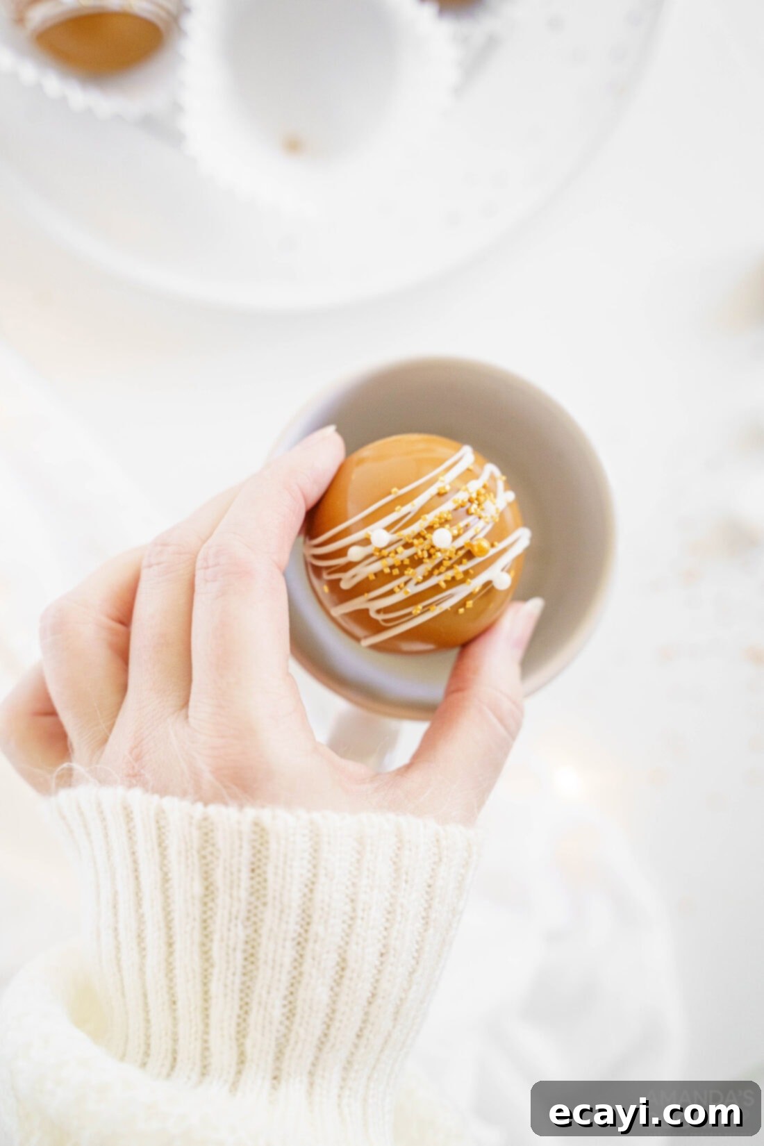 Melting Caramel Cocoa Delights 2 woman placing hot cocoa bomb in mug