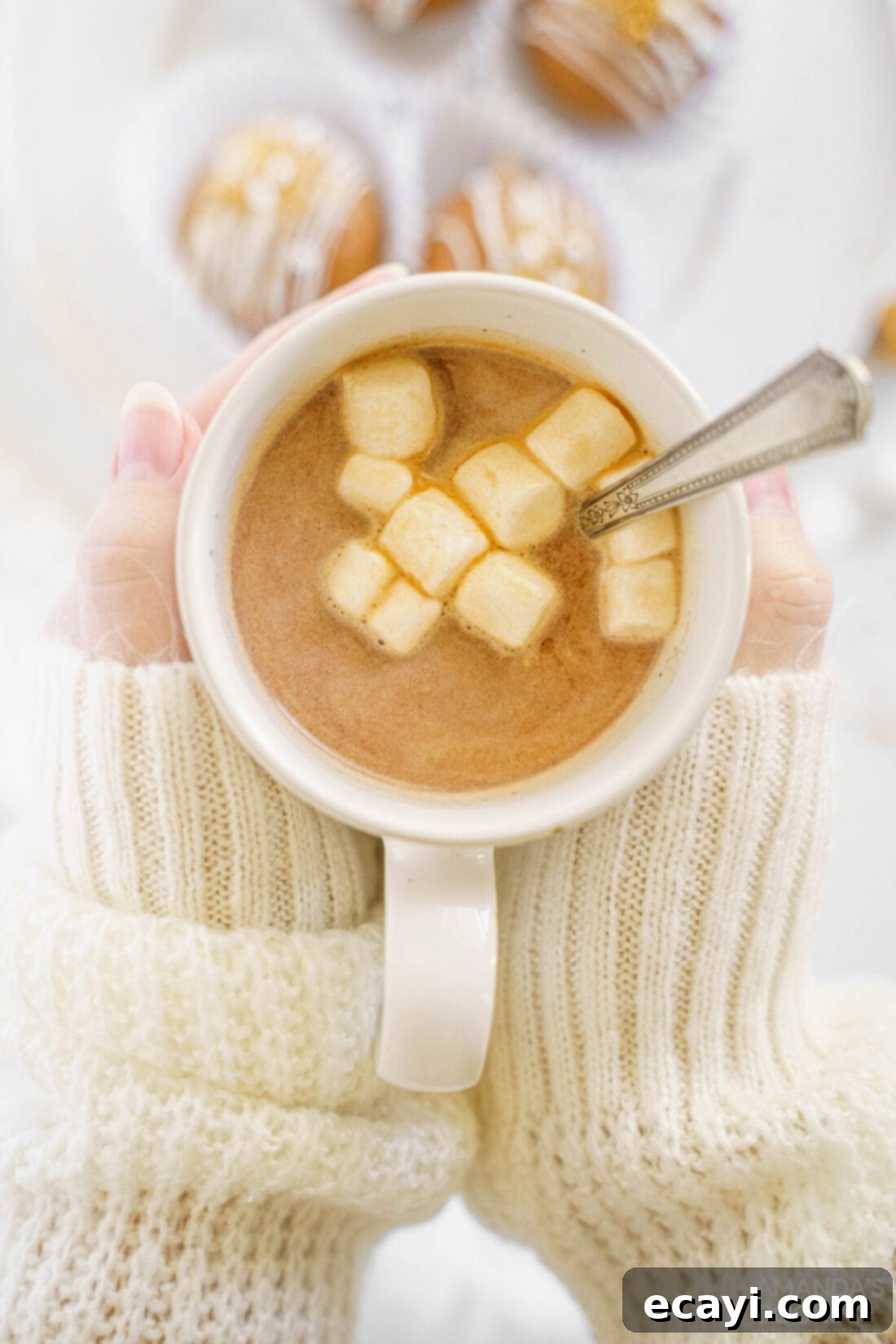 Melting Caramel Cocoa Delights 15 woman holding mug of hot cocoa