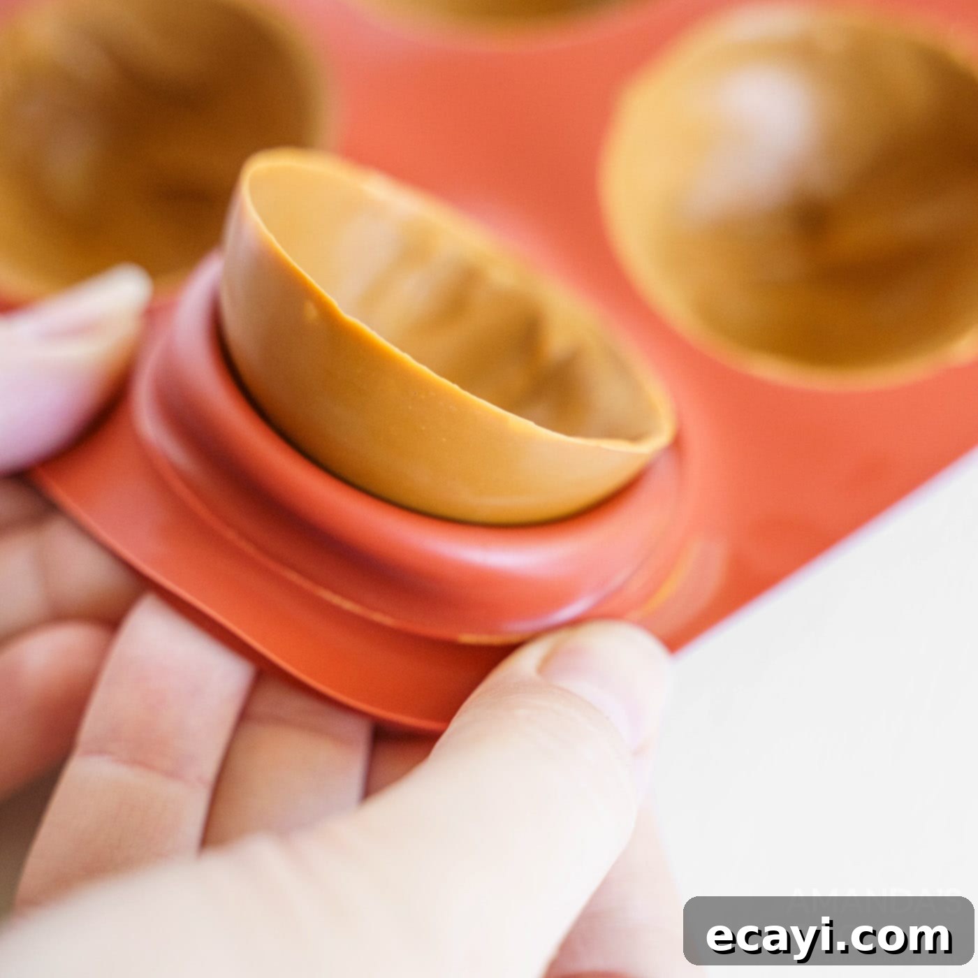Melting Caramel Cocoa Delights 7 removing half a cocoa bomb out of mold