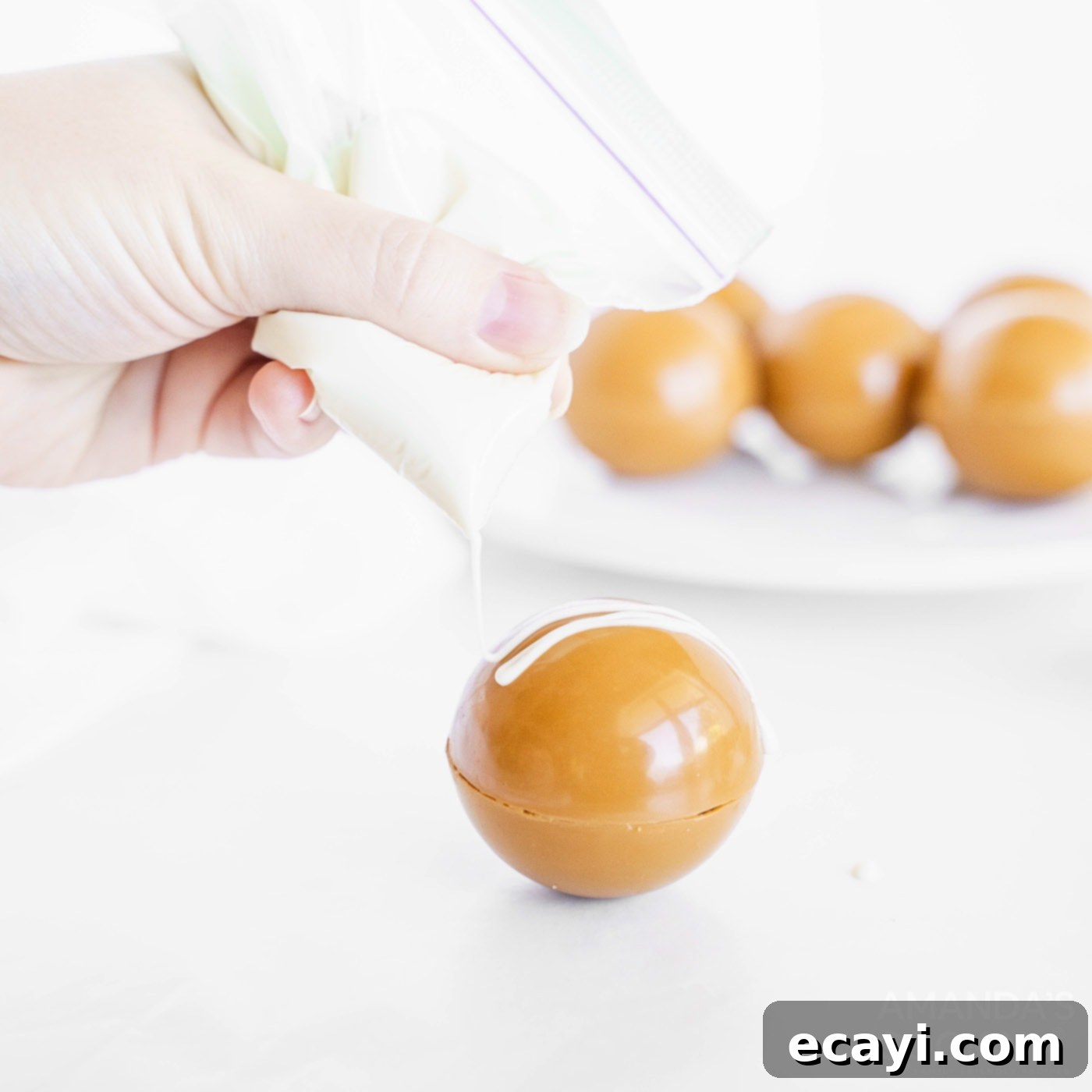 Melting Caramel Cocoa Delights 10 decorating hot cocoa bomb with white chocolate drizzles