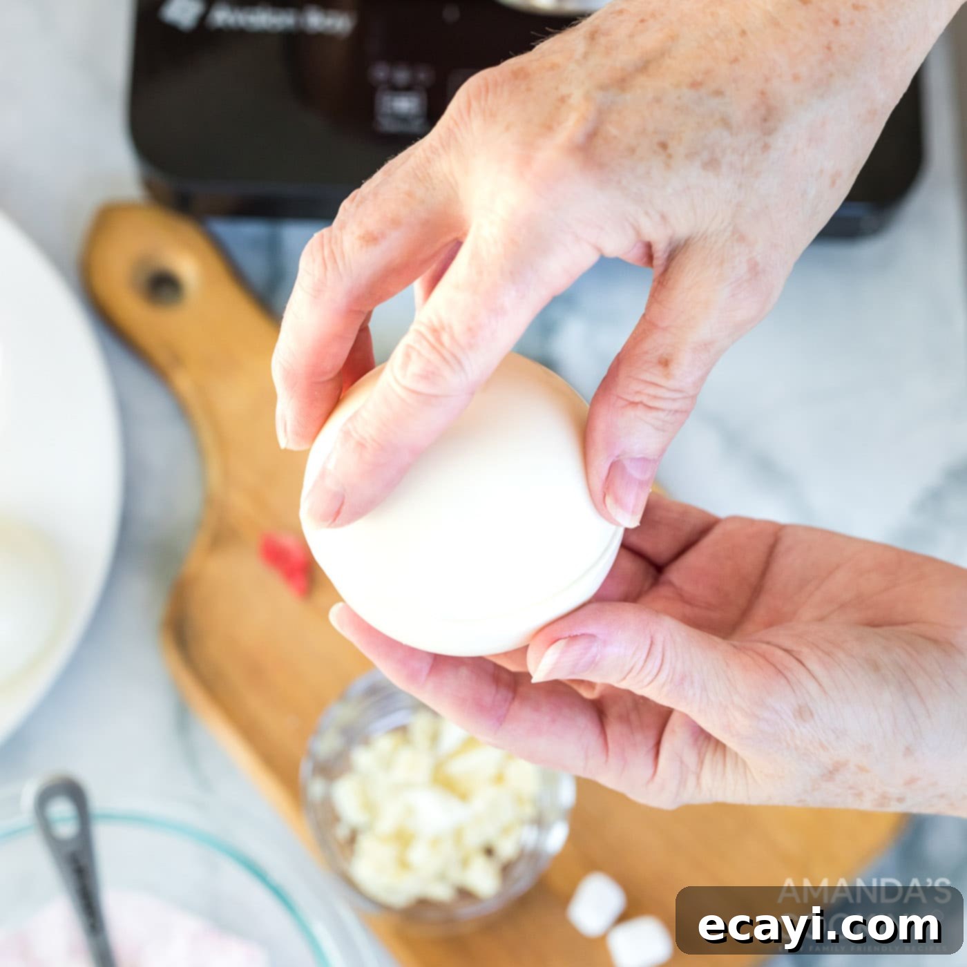Dreamy Strawberry White Chocolate Hot Cocoa Bombs 12 Carefully pressing the two smoothed chocolate sphere halves together to seal the hot cocoa bomb, creating a complete and beautiful edible sphere.