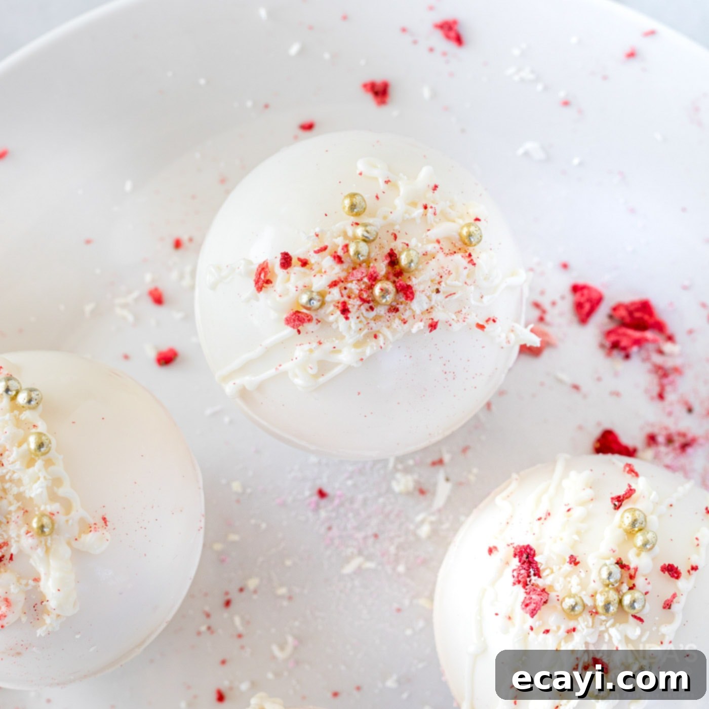 Dreamy Strawberry White Chocolate Hot Cocoa Bombs 14 A delicious strawberry white chocolate hot cocoa bomb melting in a mug, creating a creamy and inviting beverage.