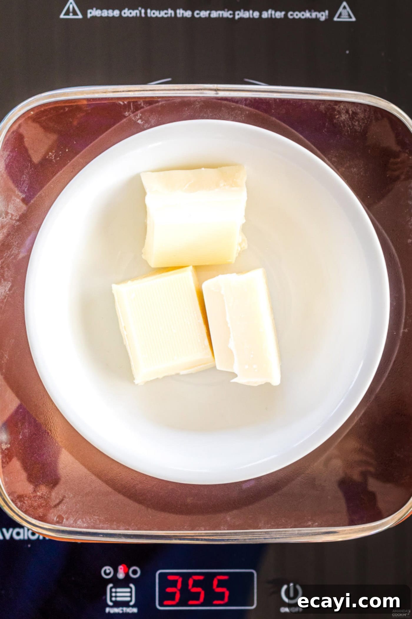Dreamy Strawberry White Chocolate Hot Cocoa Bombs 6 White chocolate melting gently in the top bowl of a double boiler, ensuring a smooth and even consistency for the hot cocoa bomb shells.
