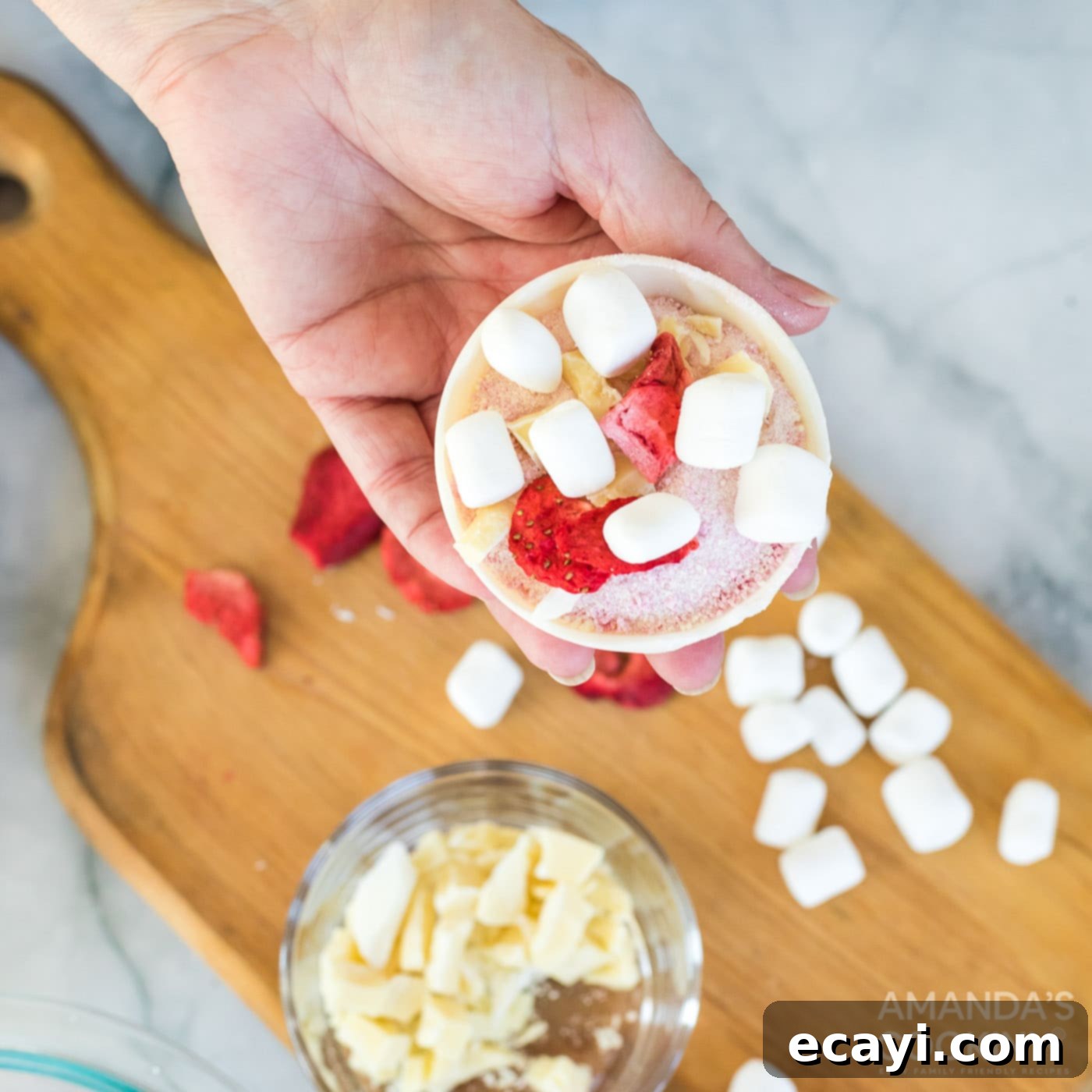 Dreamy Strawberry White Chocolate Hot Cocoa Bombs 10 Adding additional freeze-dried strawberries and fluffy mini marshmallows to the filled chocolate sphere, enhancing the flavor and texture.