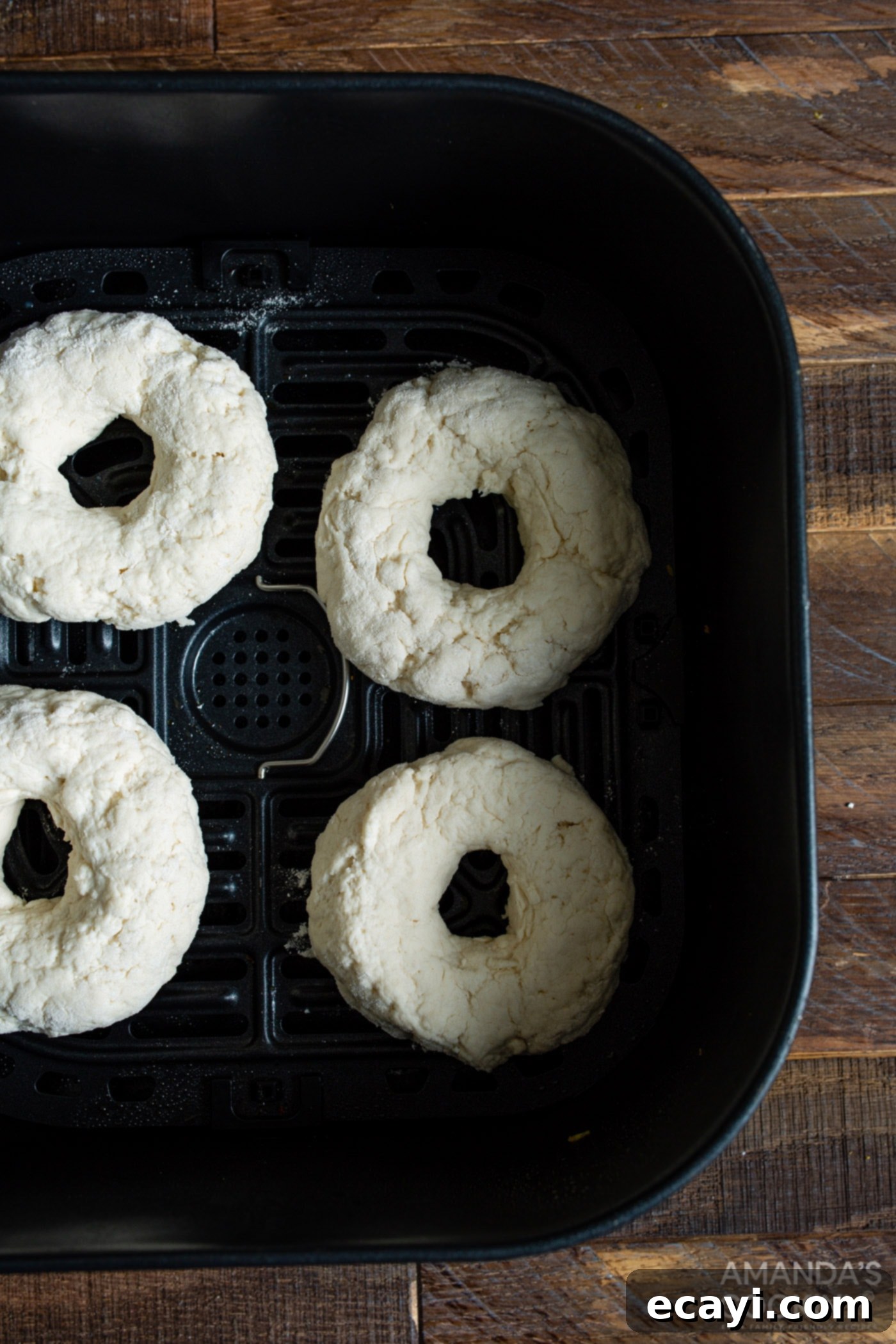 Bagel Magic in the Air Fryer 7 raw bagels in an air fryer basket