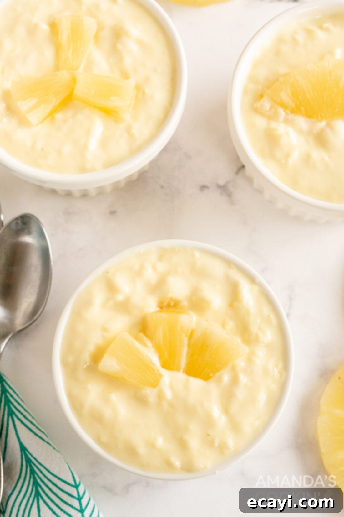 Golden Pineapple Yogurt Cloud 2 ramekins filled with pineapple yogurt dessert, garnished with fresh mint