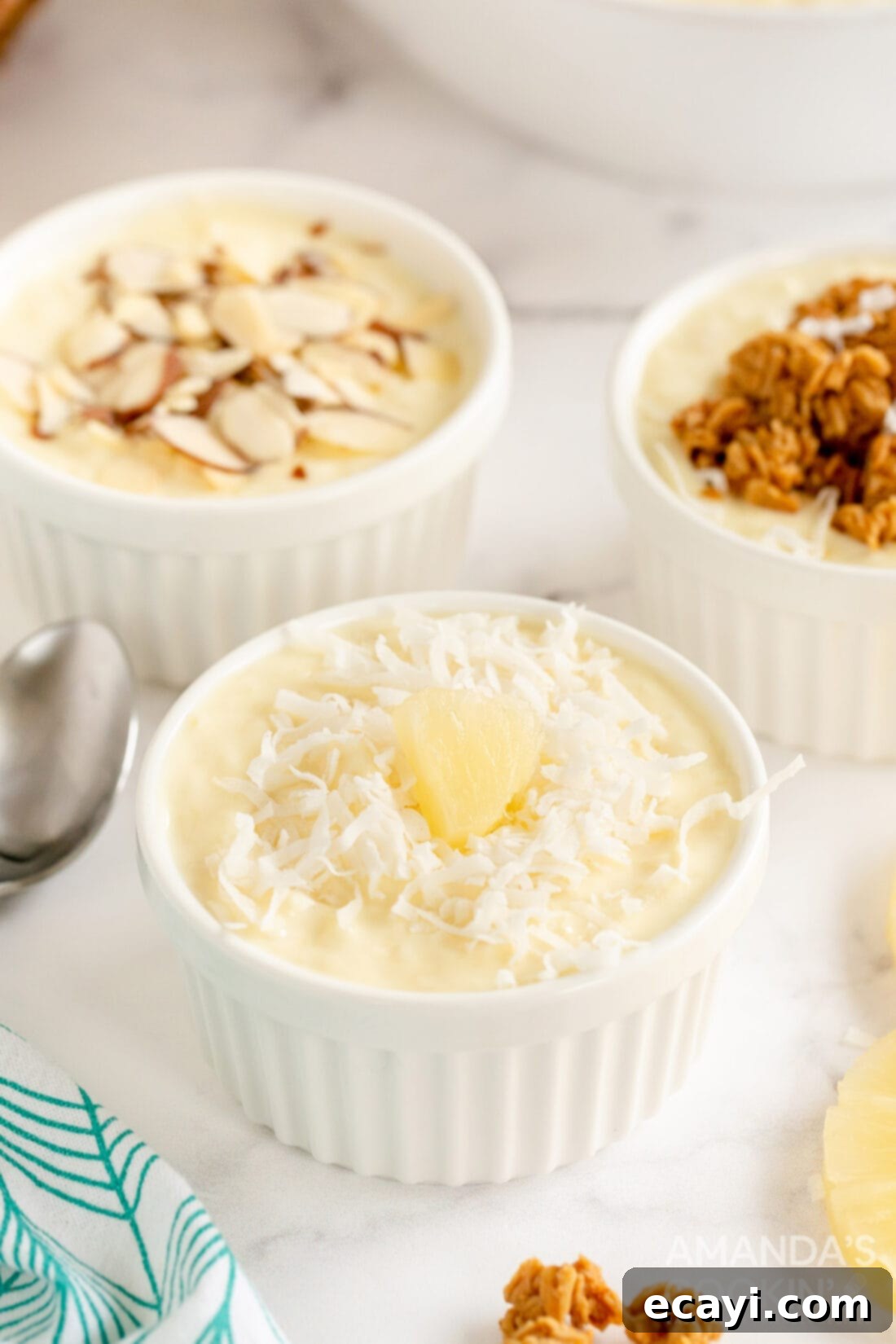 Golden Pineapple Yogurt Cloud 3 pineapple yogurt dessert with different toppings like berries, coconut, and granola