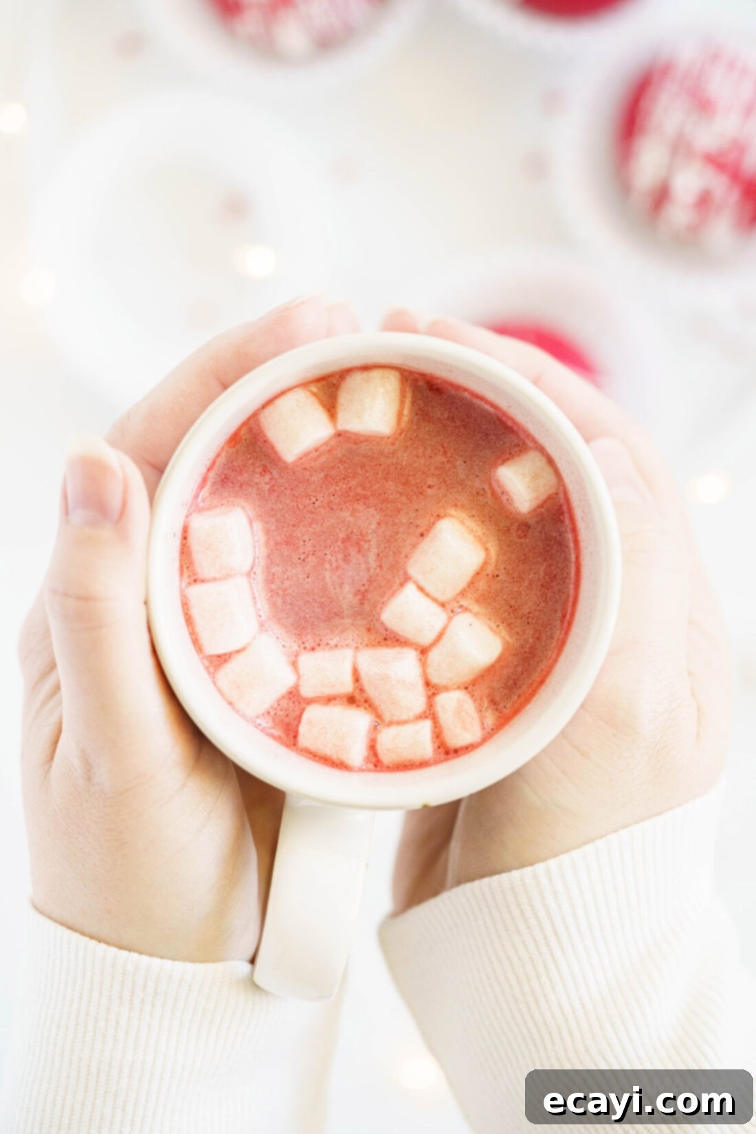Decadent Red Velvet Hot Cocoa Bombs 15 A warm mug of red velvet hot chocolate, topped with a swirl of whipped cream and a sprinkle of heart decorations.