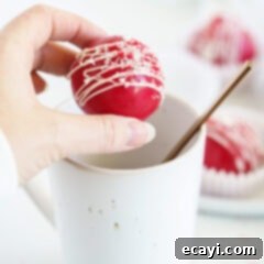 Decadent Red Velvet Hot Cocoa Bombs 17 woman holding red velvet cocoa bomb over mug