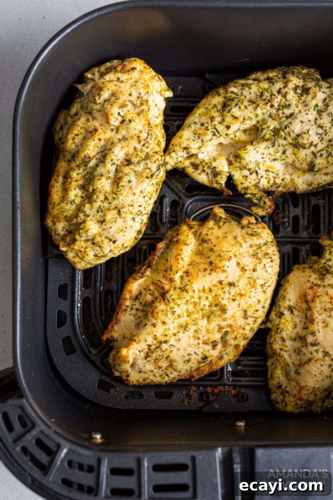 Perfect Air Fryer Chicken Breasts 2 Perfectly cooked, juicy chicken breasts in an air fryer basket, ready to be served for a quick and healthy dinner.