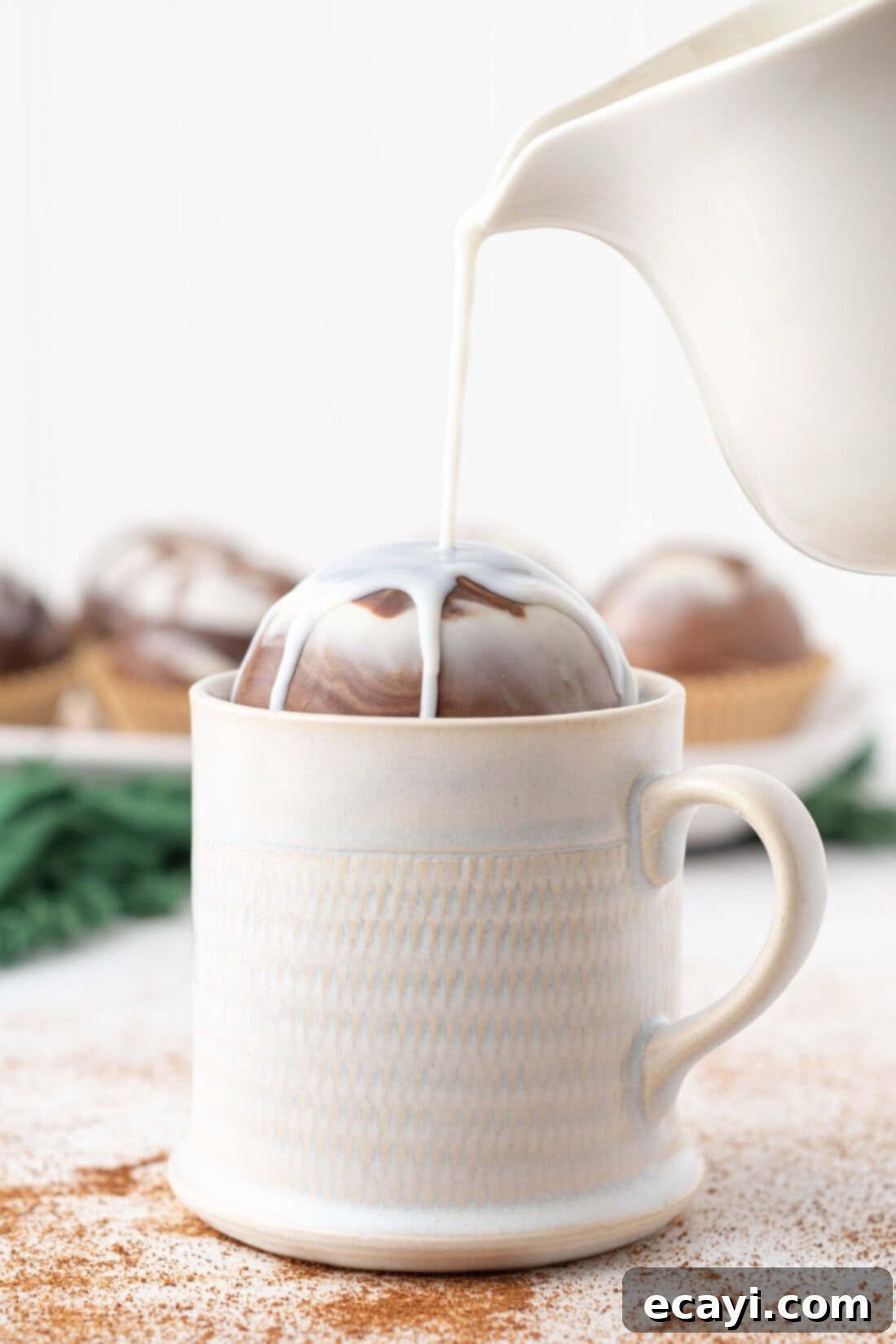 Swirled Mocha Cocoa Melts 2 pouring milk over a hot cocoa bomb