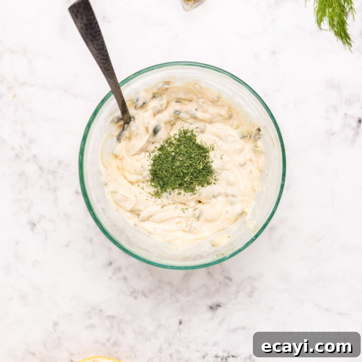 Crispy Golden Beer-Battered Fish 5 All ingredients for homemade tartar sauce - mayonnaise, dill pickle, capers, lemon juice, dill, Worcestershire, and garlic - arranged in a bowl before mixing.
