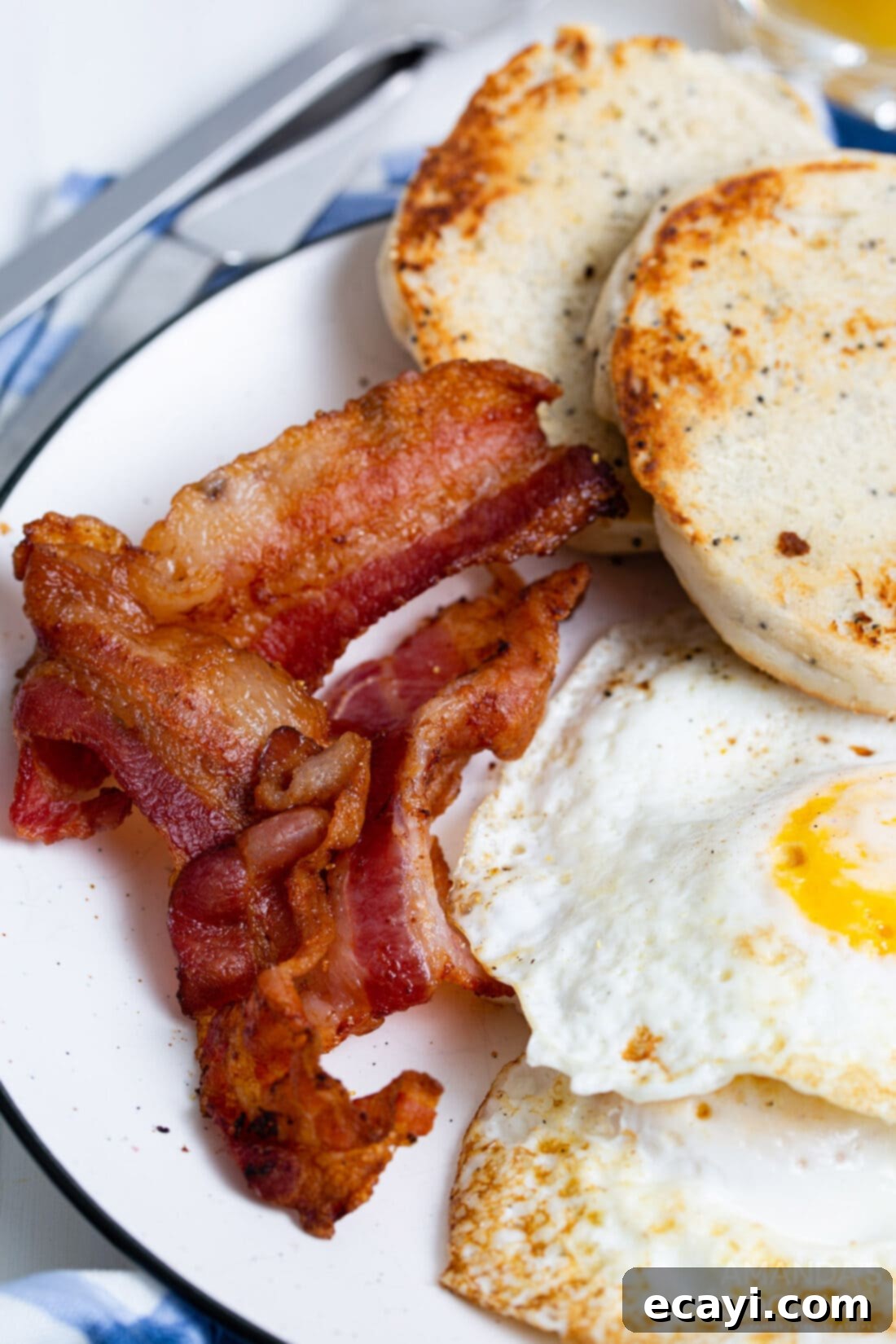 Effortless Crispy Air Fryer Bacon 7 bacon on plate with eggs