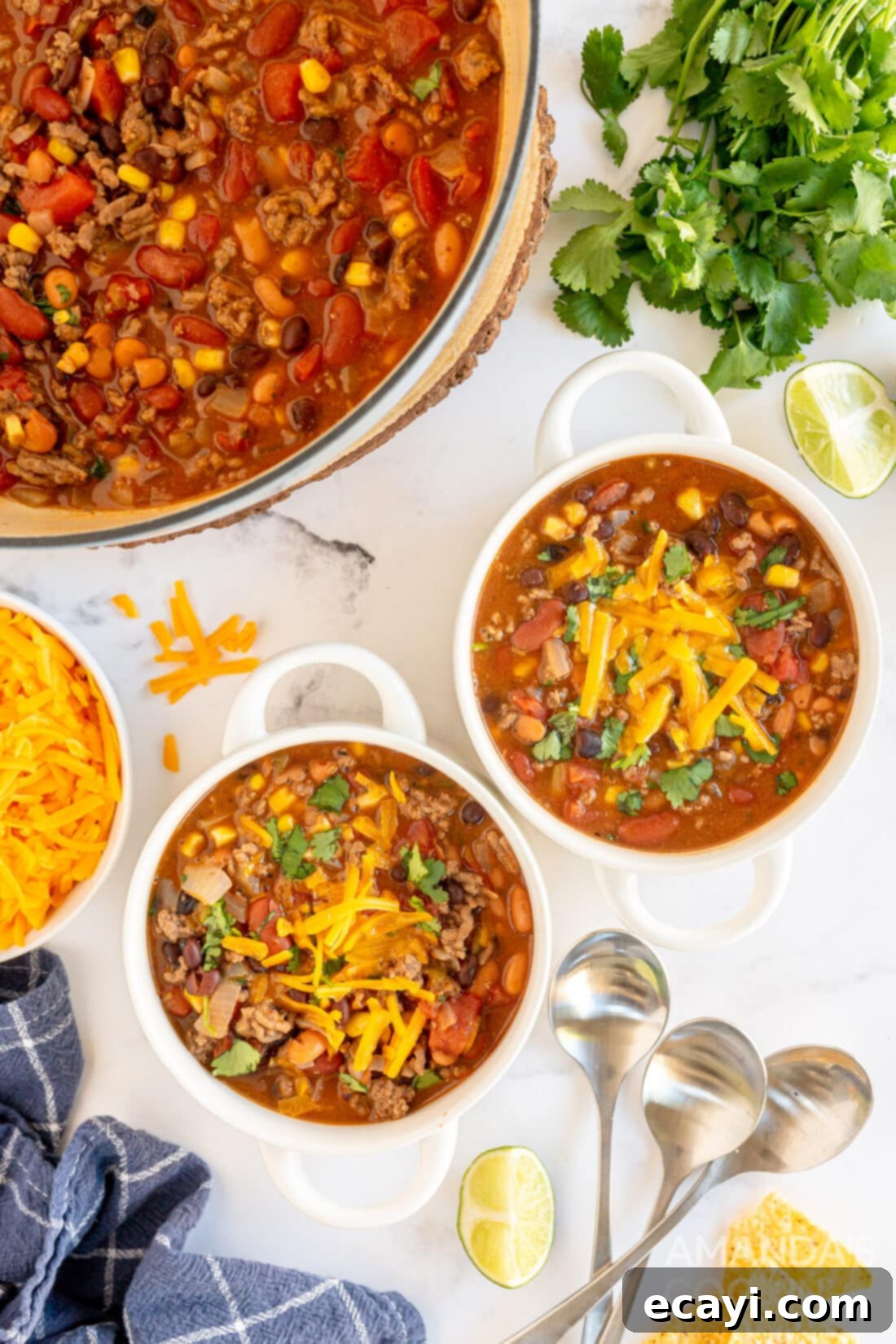 Fiesta Taco Soup 2 Two bowls of homemade taco soup garnished with cheese and tortilla chips, ready to be served.