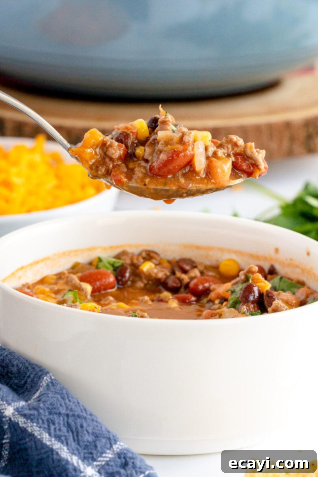 Fiesta Taco Soup 9 A spoon scooping up a generous portion of taco soup, showing the rich texture and ingredients like beef, beans, and corn.