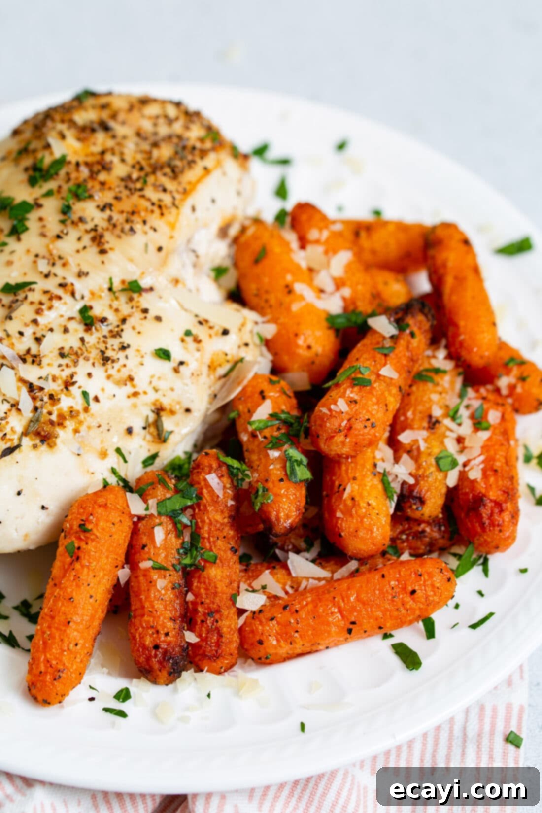 Golden Air Fryer Carrots 3 A vibrant plate featuring perfectly roasted air fryer carrots and succulent air fryer chicken breasts, showcasing a complete and healthy meal.
