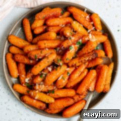 Golden Air Fryer Carrots 9 Air fryer carrots on a plate, garnished with fresh parsley.