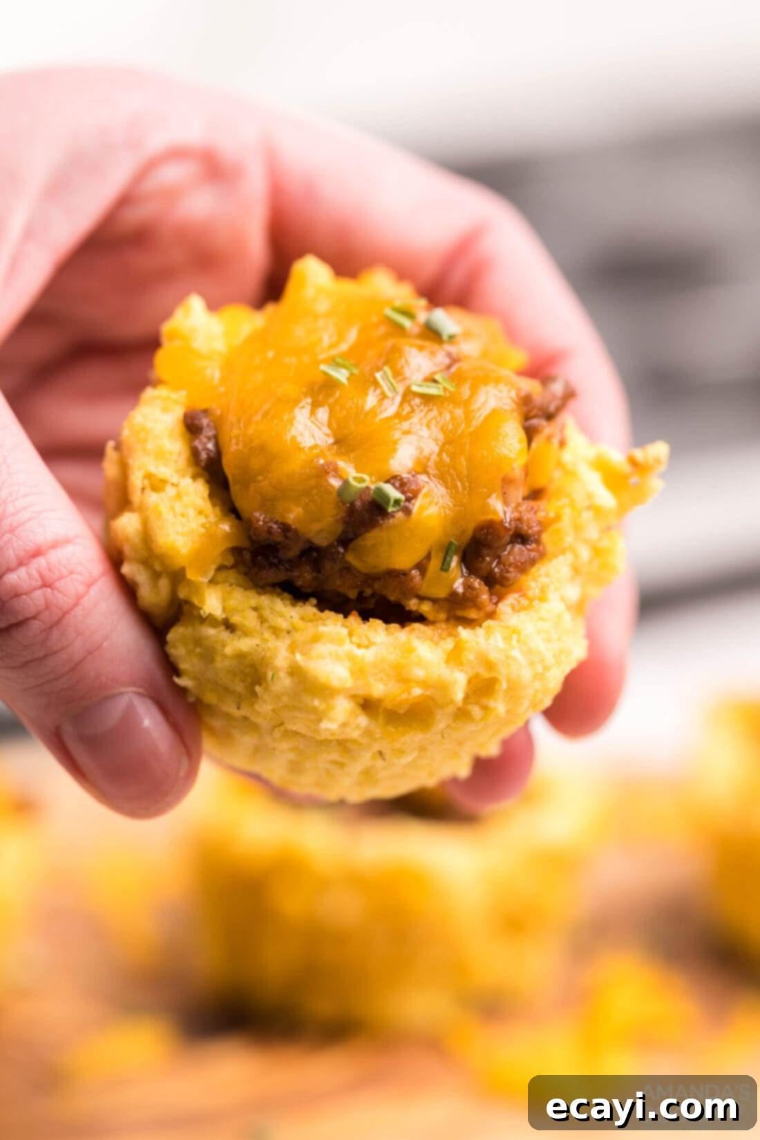 Savory Cornbread Sloppy Joe Bites 12 Woman holding a perfectly made Sloppy Joe Corn Muffin