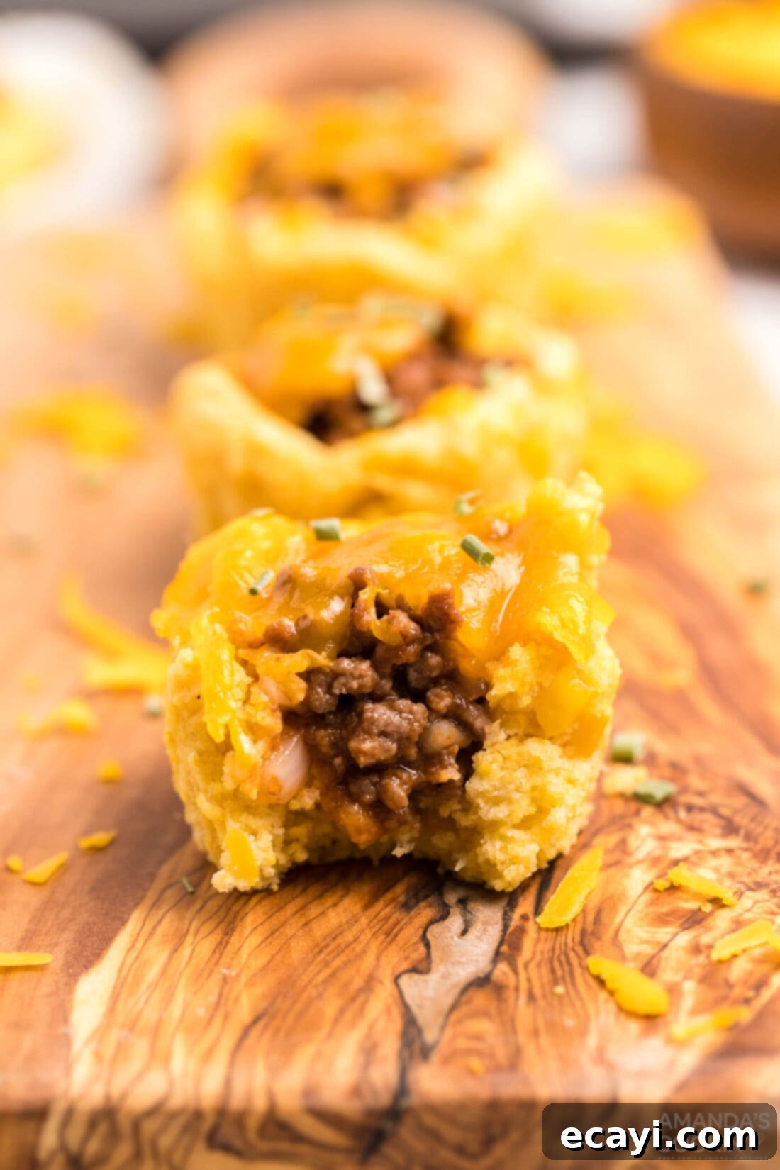 Savory Cornbread Sloppy Joe Bites 3 A delicious Sloppy Joe Corn Muffin with a bite taken out, revealing the savory filling