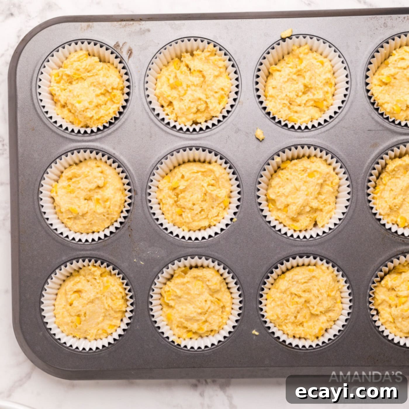Savory Cornbread Sloppy Joe Bites 7 Cornbread muffin batter poured into a muffin pan, ready for baking