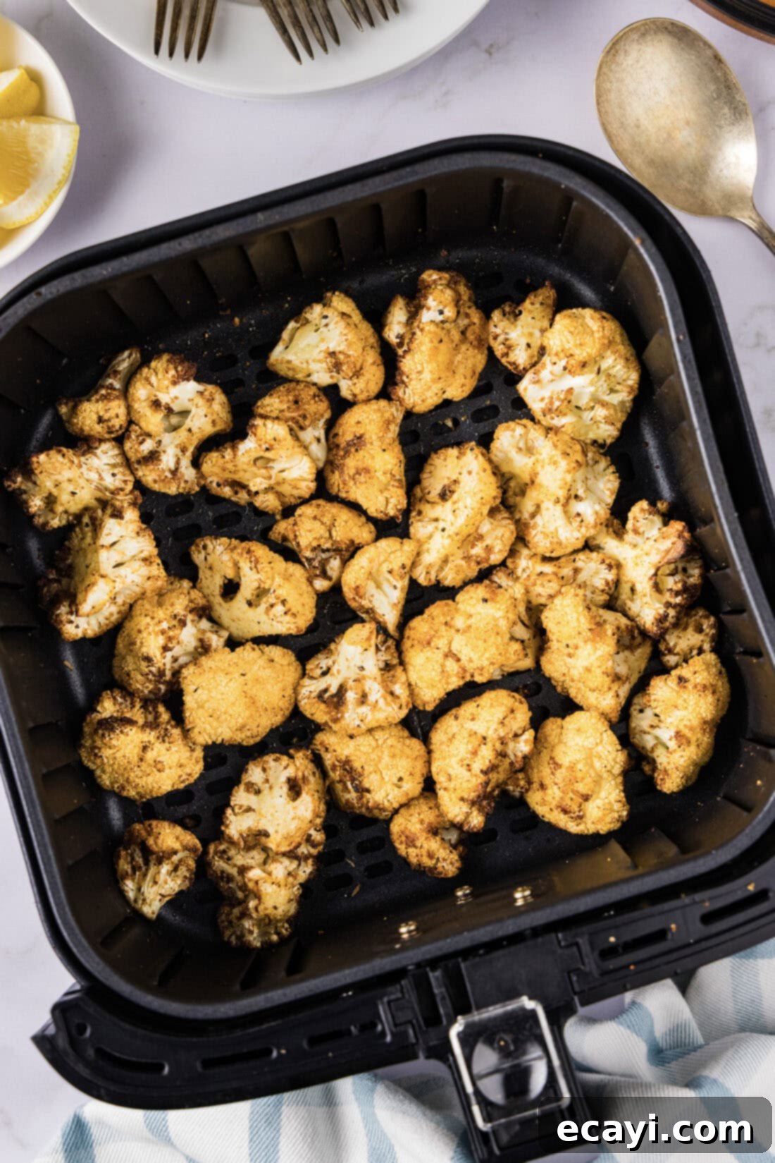 Crispy Air Fryer Cauliflower 2 Air Fryer Cauliflower resting in an air fryer basket