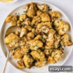 Crispy Air Fryer Cauliflower 9 Plate of Air Fryer Cauliflower with a serving spoon on the side