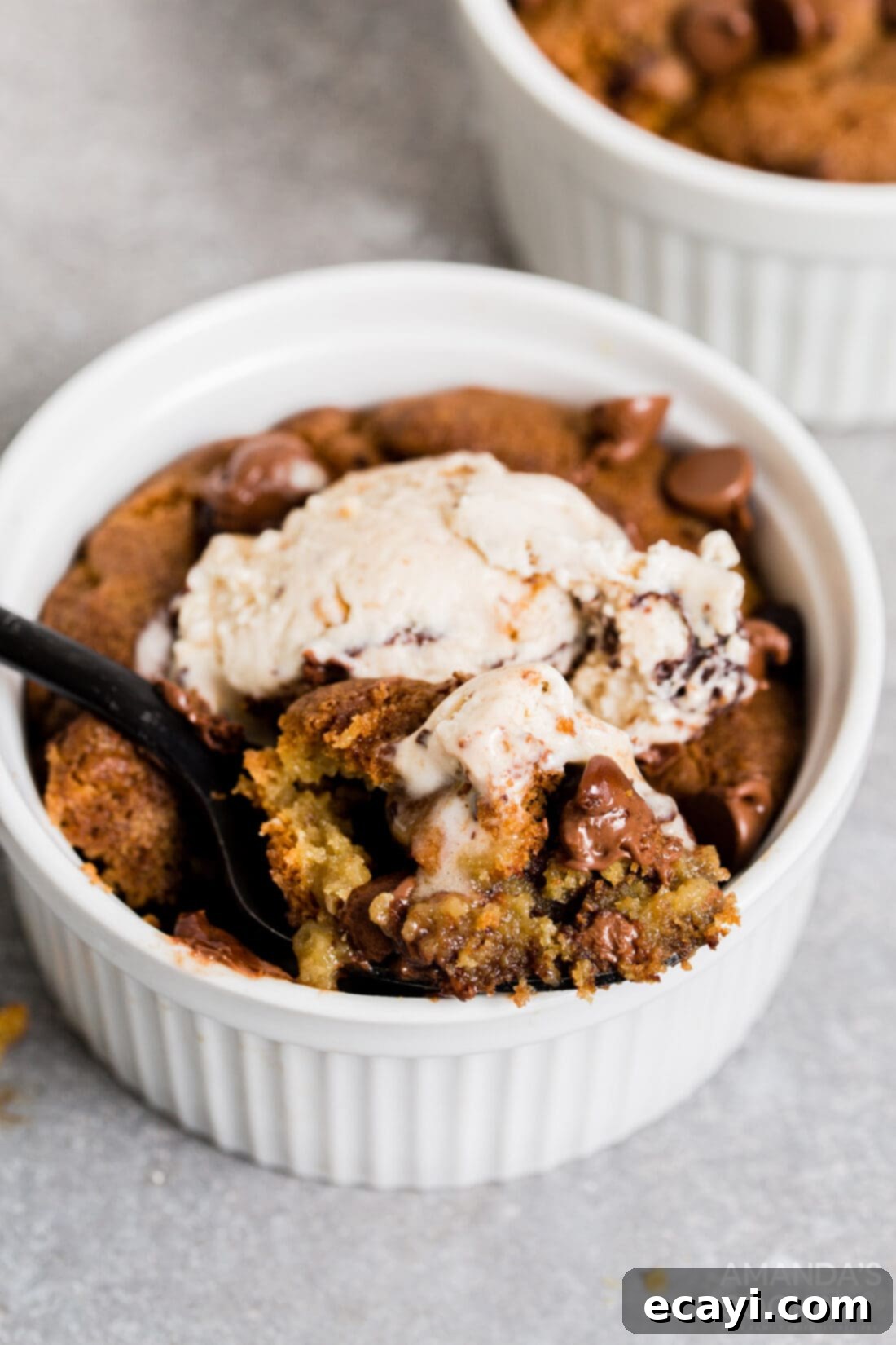 Your Air Fryer's Best Chocolate Chip Cookies 12 Air fryer chocolate chip cookie in a ramekin topped with melting vanilla ice cream