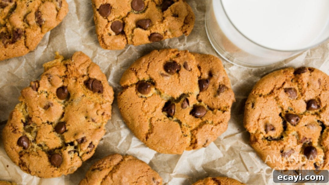 Your Air Fryer's Best Chocolate Chip Cookies 13 A stack of golden brown air fryer chocolate chip cookies on a white plate