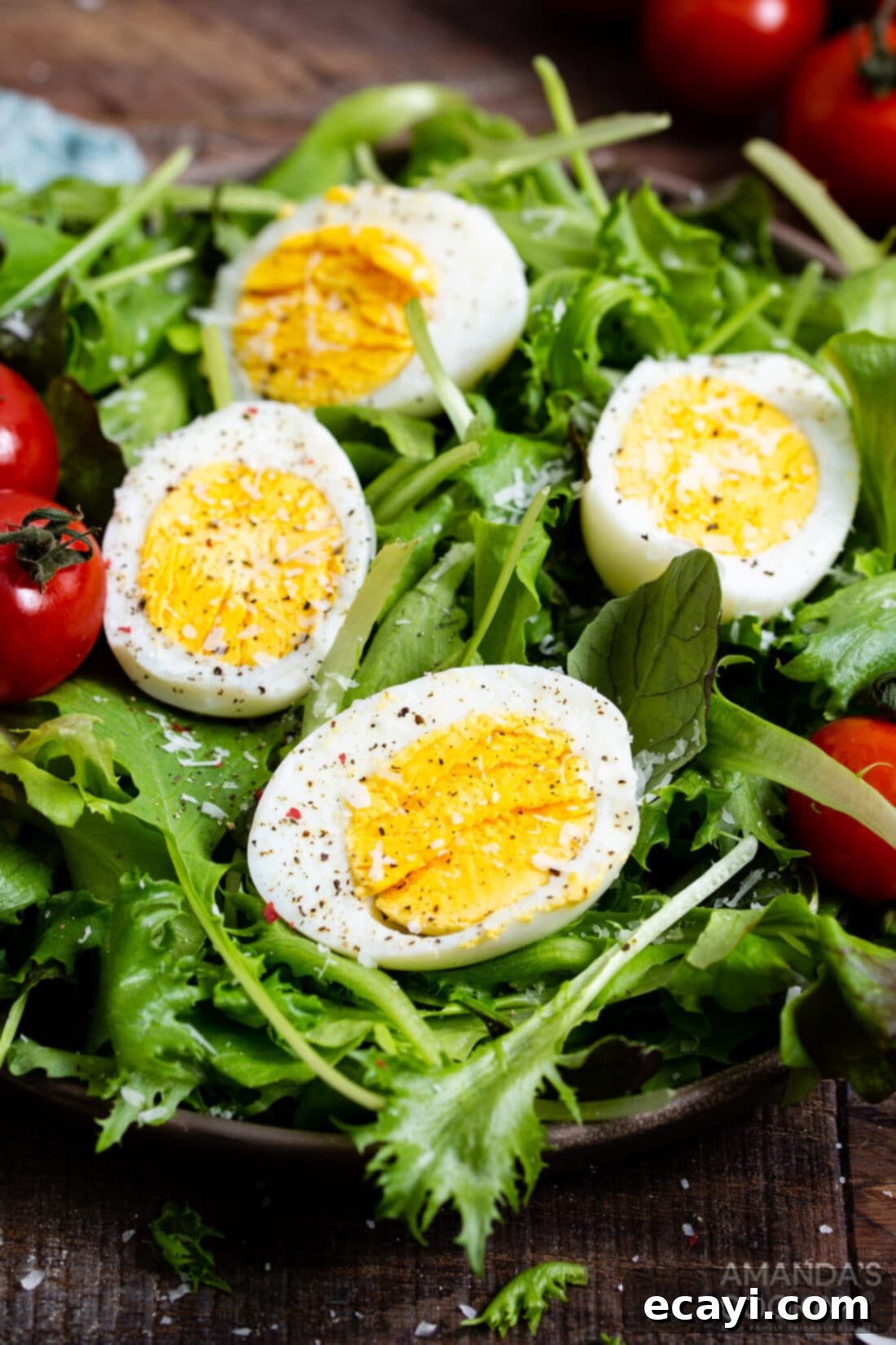 Hard Boiled Eggs in the Air Fryer 7 sliced hard boiled eggs on a fresh green salad