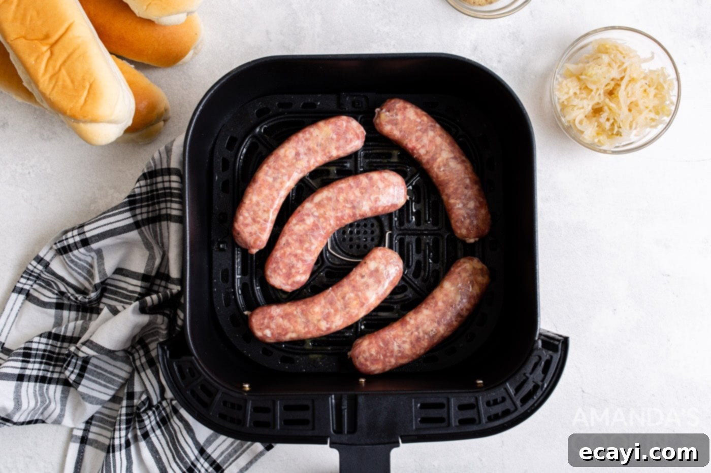 Crispy Air Fryer Bratwurst 5 bratwurst in an air fryer tray