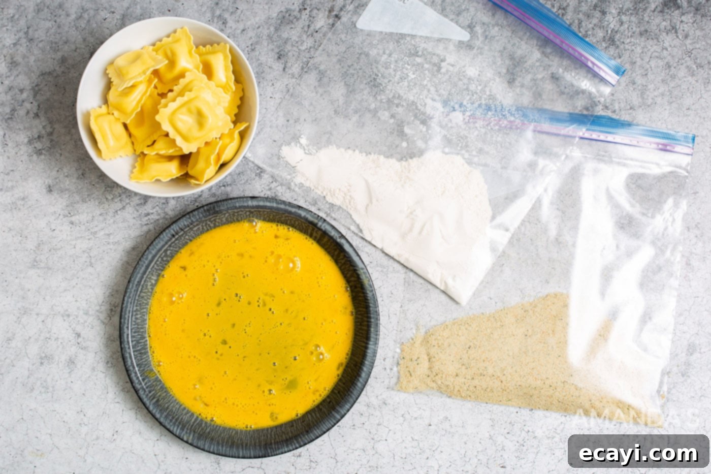 Crispy Air Fryer Ravioli 5 Two Ziploc bags, one with flour and one with breadcrumbs, next to a bowl of beaten eggs, ready for the dipping station setup