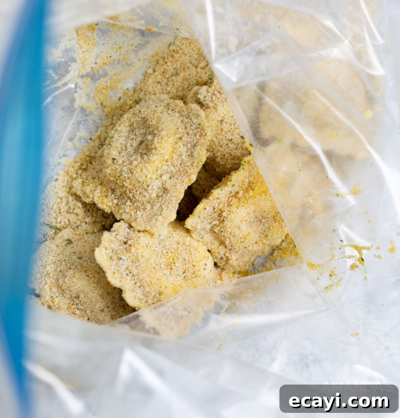 Crispy Air Fryer Ravioli 8 Ravioli being coated in Italian seasoned breadcrumbs inside a Ziploc bag