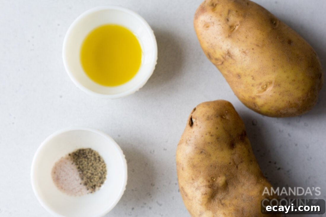 Perfectly Crispy Air Fryer Fries 4 Arrangement of ingredients for air fryer french fries including Yukon gold potatoes, olive oil, salt, and pepper.
