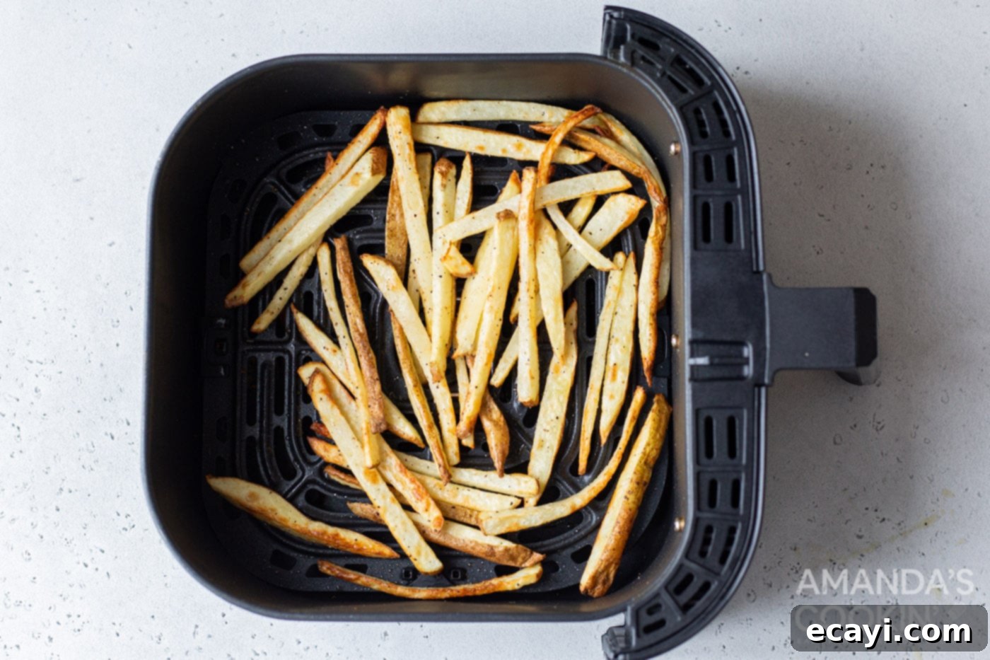 Perfectly Crispy Air Fryer Fries 8 Perfectly cooked, golden and crispy air fryer french fries inside the air fryer basket.