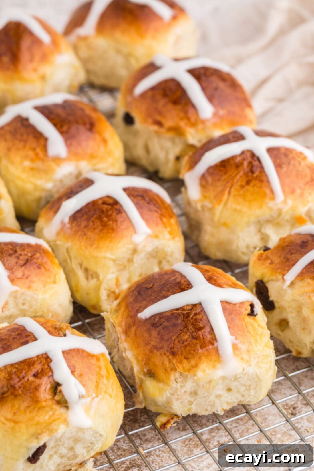 Spiced Easter Buns 37 Freshly baked Hot Cross Buns cooling on a wire rack, glistening with icing crosses.